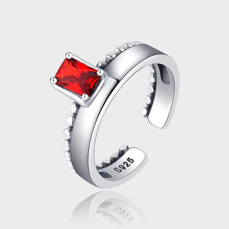 An exquisite 925 silver ring with an open design, highlighted by a radiant zirconia stone.